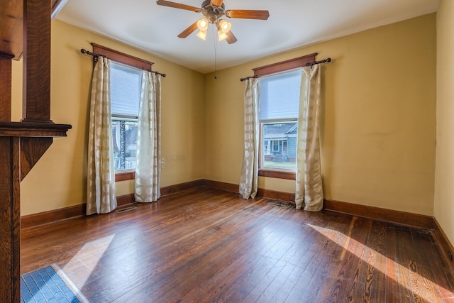 spare room with ceiling fan and dark wood-type flooring