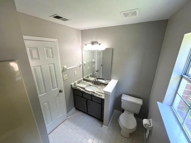 bathroom featuring tile patterned floors, vanity, and toilet