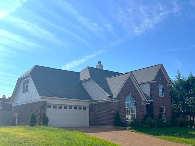 view of property featuring a garage and a front yard