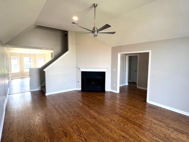 unfurnished living room featuring ceiling fan, dark hardwood / wood-style flooring, and lofted ceiling