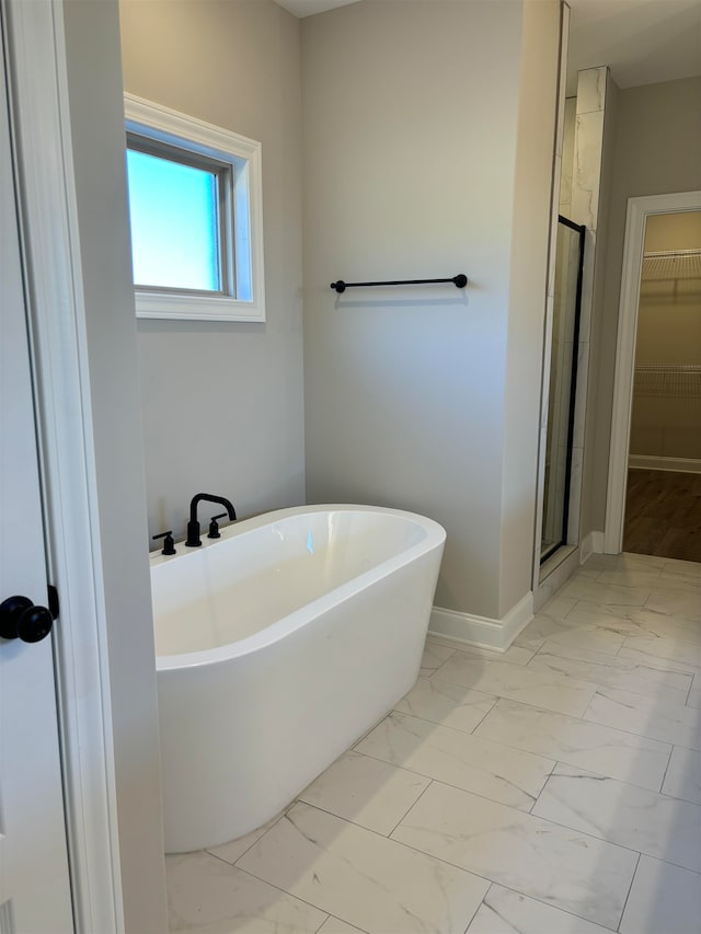 bathroom featuring separate shower and tub