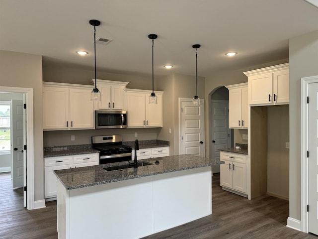 kitchen featuring white cabinetry, visible vents, stainless steel appliances, and a sink