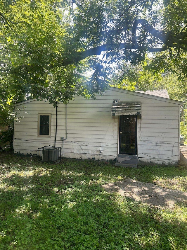 rear view of property with cooling unit