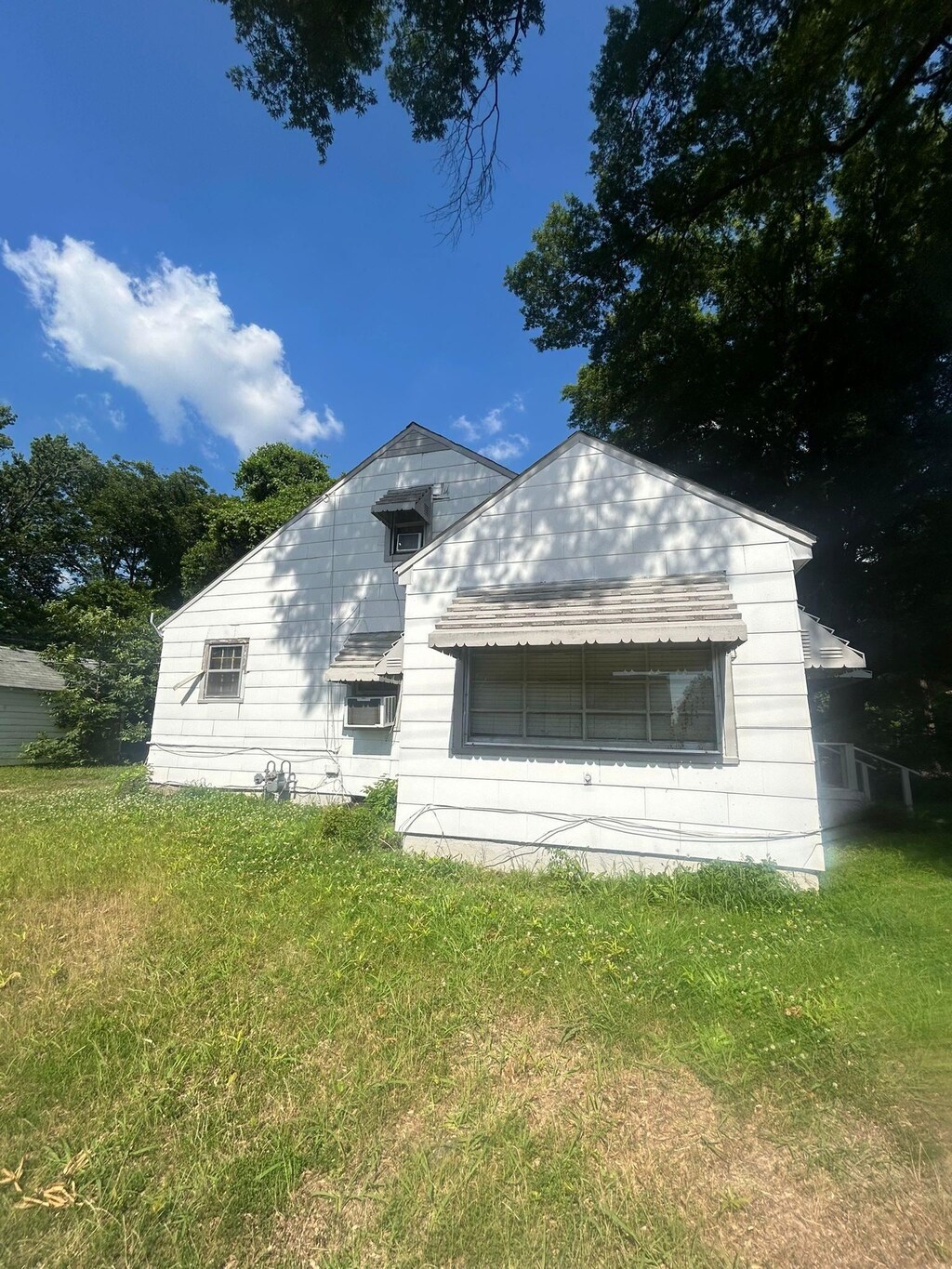 back of house with a lawn