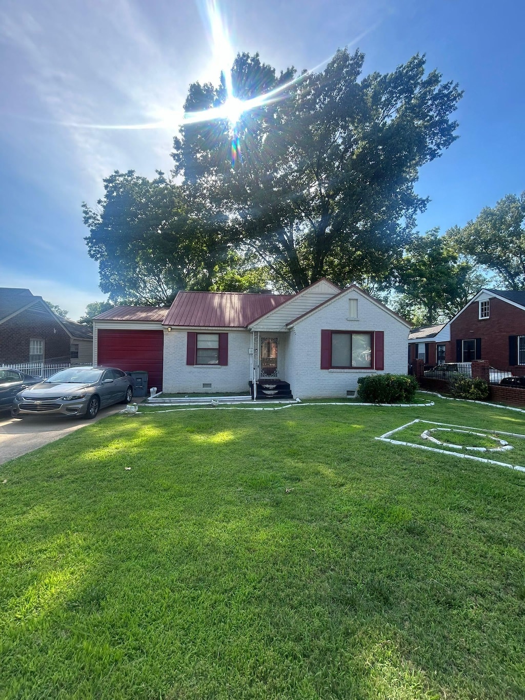 single story home with a front yard and a garage