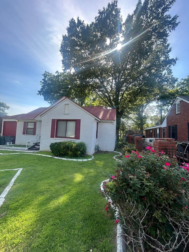 view of side of home with a lawn