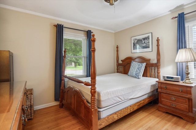 bedroom with ceiling fan, light hardwood / wood-style floors, crown molding, and multiple windows