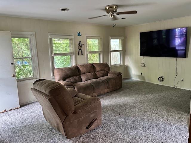 carpeted living room with ceiling fan