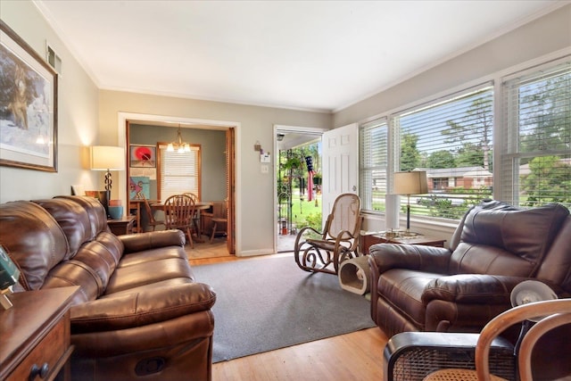 living room with crown molding and light hardwood / wood-style floors