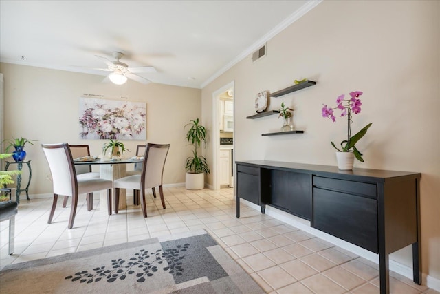 tiled dining room with ceiling fan and crown molding