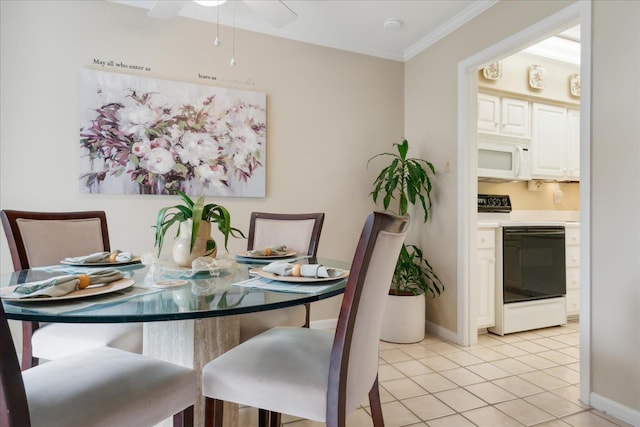 dining area with light tile patterned floors and ornamental molding