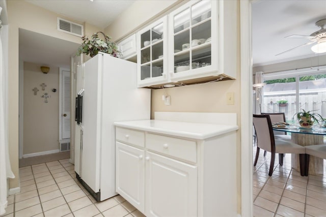 kitchen featuring white cabinetry, light tile patterned floors, white fridge, and ceiling fan