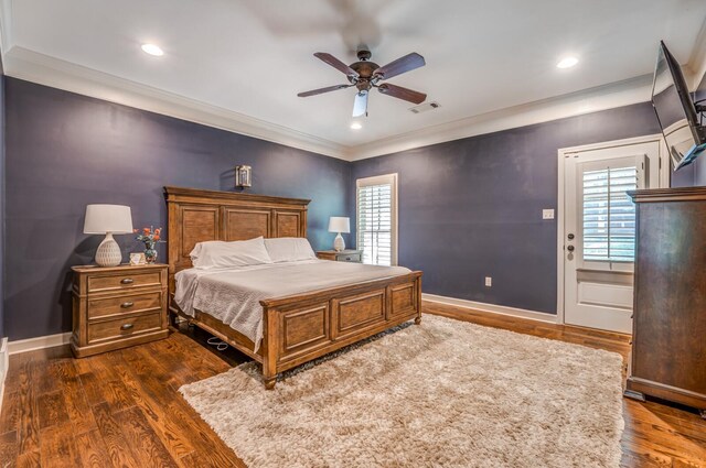 bedroom with dark wood-style floors, multiple windows, and visible vents