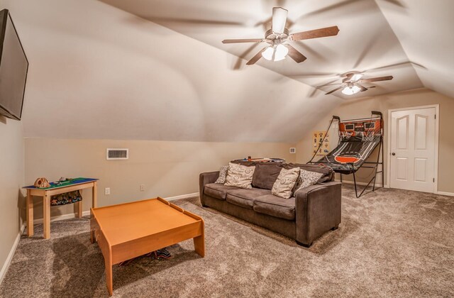 carpeted living area featuring a ceiling fan, visible vents, vaulted ceiling, and baseboards