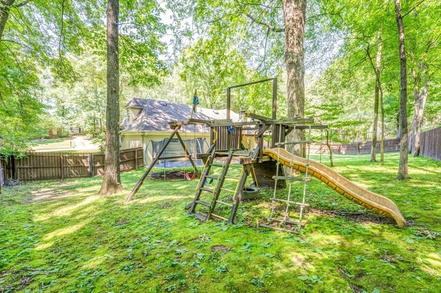 view of playground with a fenced backyard and a yard