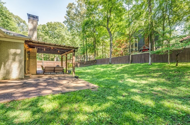 view of yard featuring fence and a patio