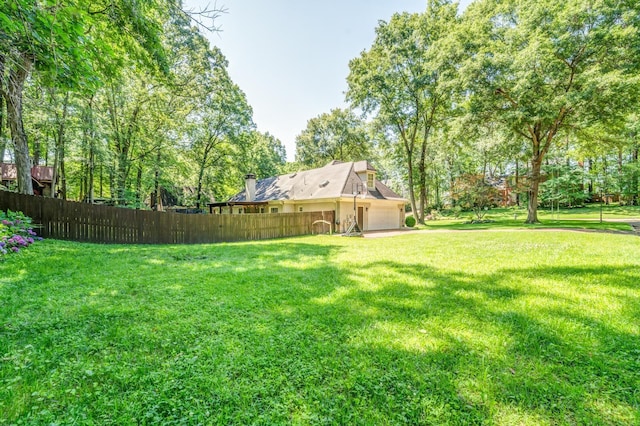 view of yard with a garage and fence