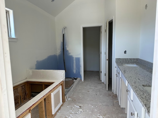 bathroom with vanity and lofted ceiling