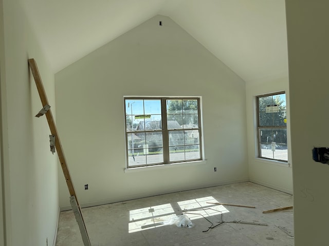 unfurnished room featuring high vaulted ceiling