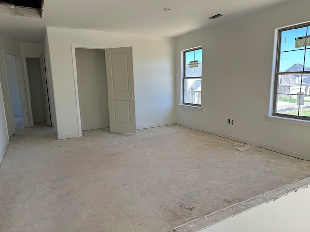 unfurnished bedroom featuring multiple windows