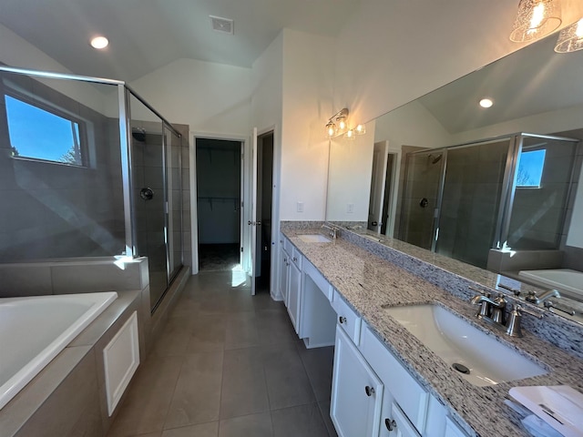 bathroom with tile patterned floors, vanity, separate shower and tub, and lofted ceiling