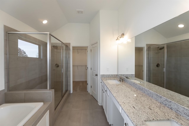 bathroom with tile patterned flooring, vanity, independent shower and bath, and high vaulted ceiling