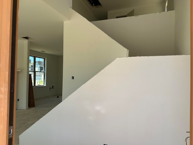 stairway with concrete flooring