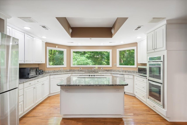 kitchen featuring white cabinets, a kitchen island, and stainless steel appliances