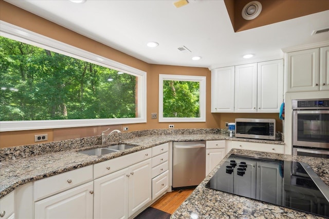 kitchen featuring white cabinetry, sink, and stainless steel appliances