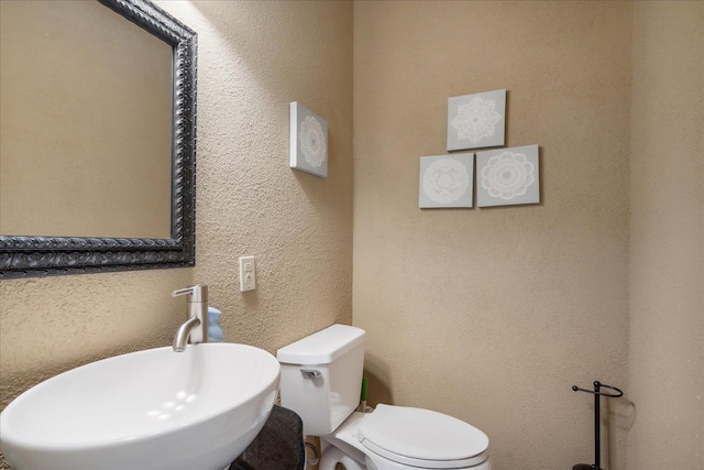 bathroom featuring toilet and sink