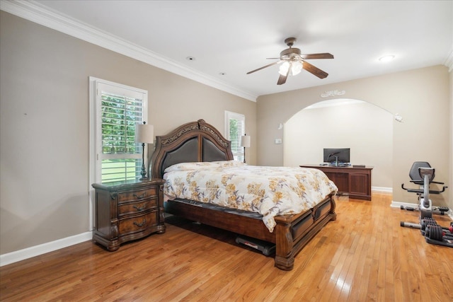 bedroom with ceiling fan, ornamental molding, and light wood-type flooring