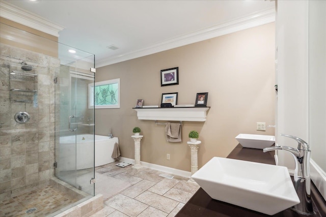 bathroom featuring double sink, a shower with door, and crown molding