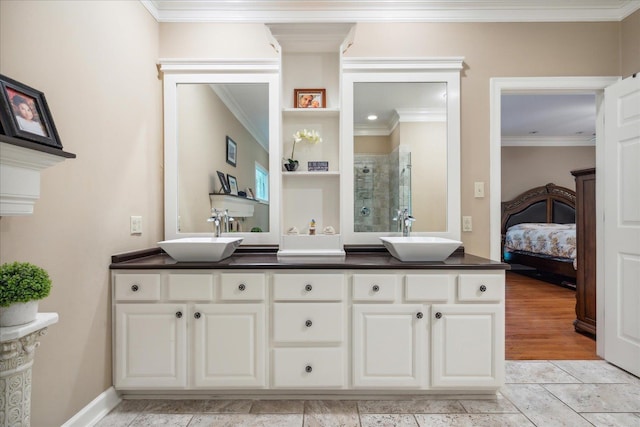 bathroom featuring vanity, a shower with shower door, and ornamental molding