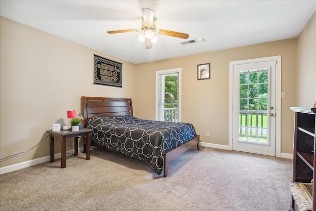 carpeted bedroom with ceiling fan, access to outside, and multiple windows