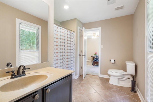 bathroom with tile patterned flooring, vanity, and toilet