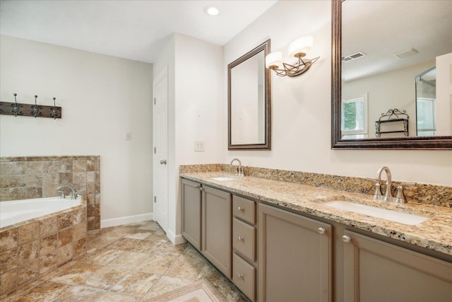 bathroom featuring vanity and tiled tub