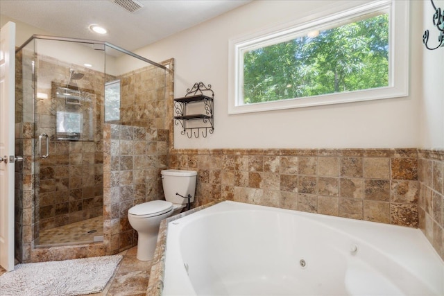 bathroom featuring toilet and independent shower and bath