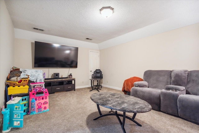 living room with a textured ceiling and carpet floors