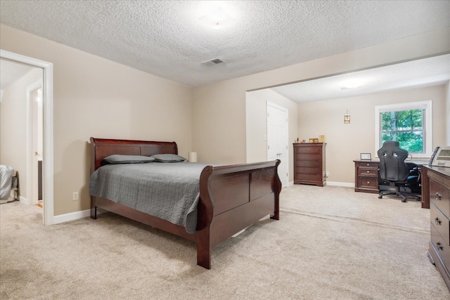 carpeted bedroom featuring a textured ceiling