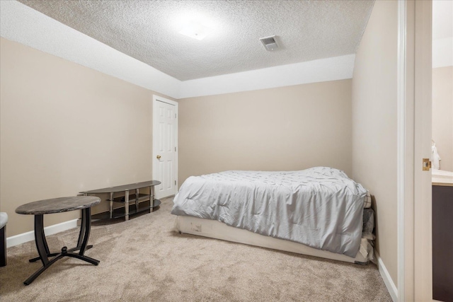 carpeted bedroom featuring a textured ceiling