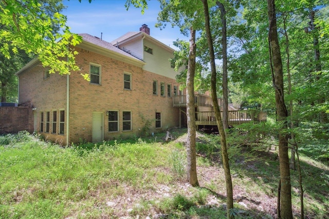 rear view of property featuring a deck