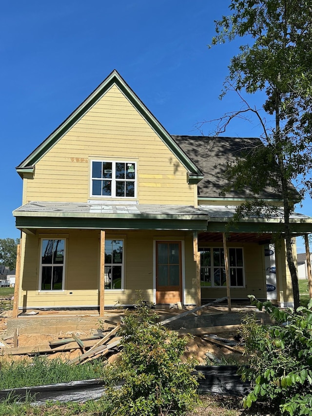 rear view of property with a porch