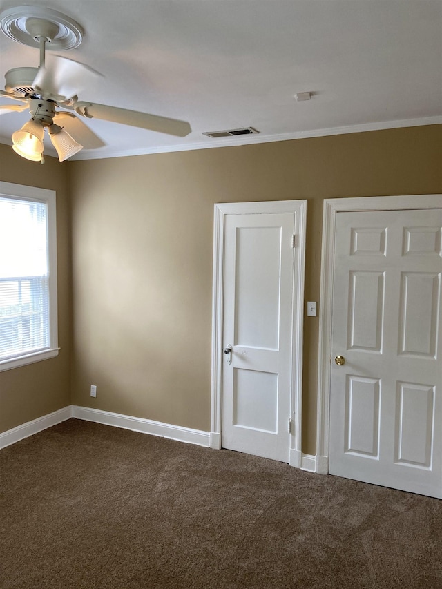 spare room featuring carpet flooring, ceiling fan, and ornamental molding