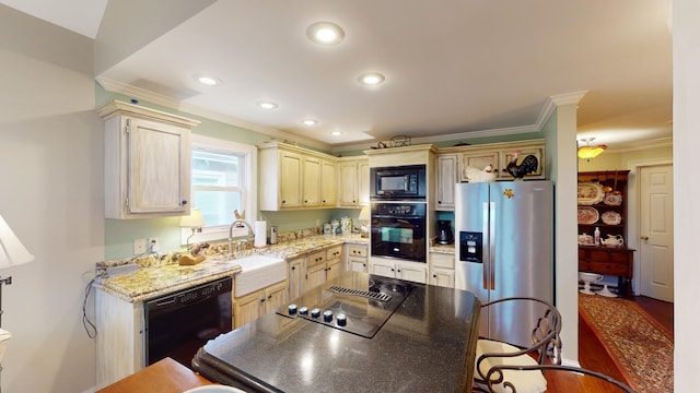 kitchen featuring light stone counters, ornamental molding, dark wood-type flooring, sink, and black appliances