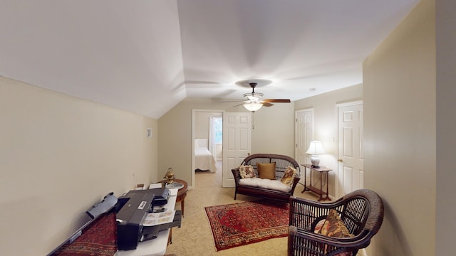 living area featuring ceiling fan, carpet, and vaulted ceiling