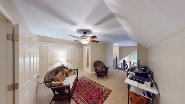 living area featuring carpet, ceiling fan, and lofted ceiling