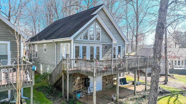 rear view of house with a wooden deck and a patio area