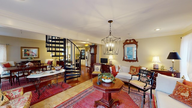 living room featuring crown molding, wood-type flooring, and a notable chandelier