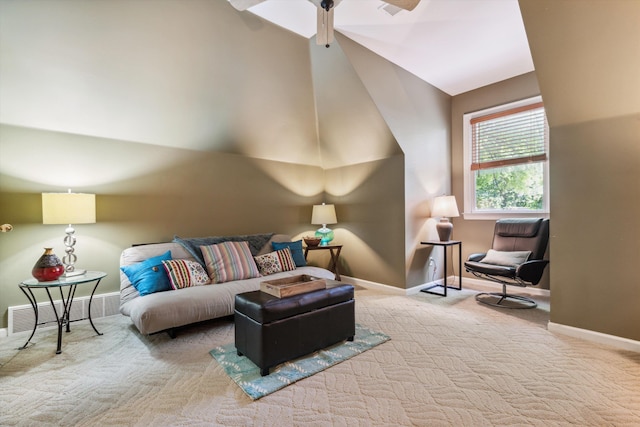 carpeted living room featuring ceiling fan and lofted ceiling