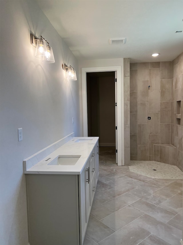 bathroom featuring vanity and tiled shower